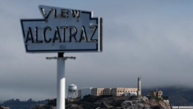 A view of Alcatraz Island with a blurry "VIEW ALCATRAZ" sign in the foreground.