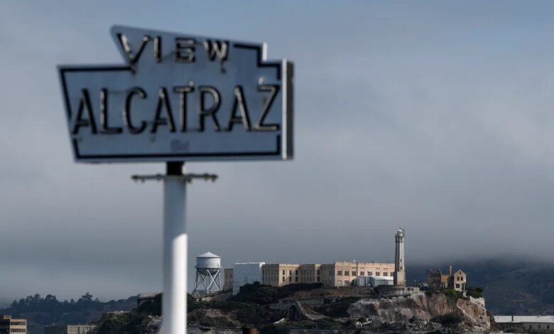 A view of Alcatraz Island with a blurry "VIEW ALCATRAZ" sign in the foreground.