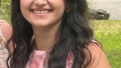 Brittany Kritis-Garip, a missing woman from Nassau County, smiling while wearing a pink floral top.