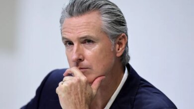 Gavin Newsom, governor of California, with his hand on his chin.