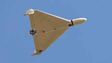 Iranian-made Shahed-136 'Kamikaze' drone flying over a blue sky.
