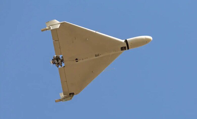 Iranian-made Shahed-136 'Kamikaze' drone flying over a blue sky.