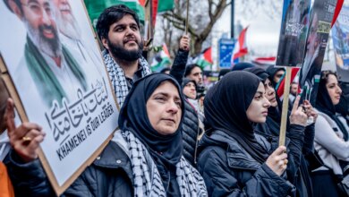 Pro-Iranian regime British-Iranians at a rally in London holding posters of Ayatollah Ali Khamenei.