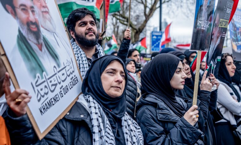 Pro-Iranian regime British-Iranians at a rally in London holding posters of Ayatollah Ali Khamenei.