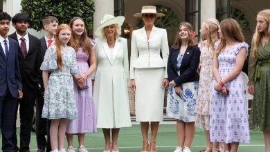 First lady Melania Trump and Queen Camilla standing with students at White House Tennis Pavilion