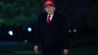 President Donald Trump talks to reporters as he walks on the South Lawn upon his arrival to the White House, Sunday, April 12, 2026, in Washington. (AP Photo/Jose Luis Magana)