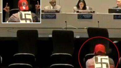 Swastika-wearing agitator makes profane gestures at LAPD officials