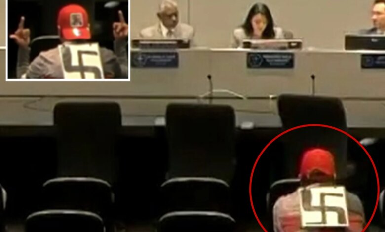 Swastika-wearing agitator makes profane gestures at LAPD officials