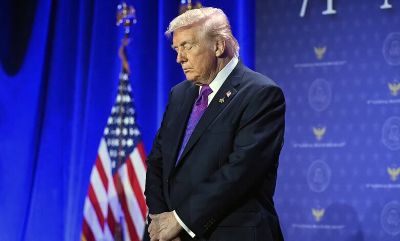 President Donald Trump bows his head in prayer at the National Prayer Breakfast in Washington, D.C.