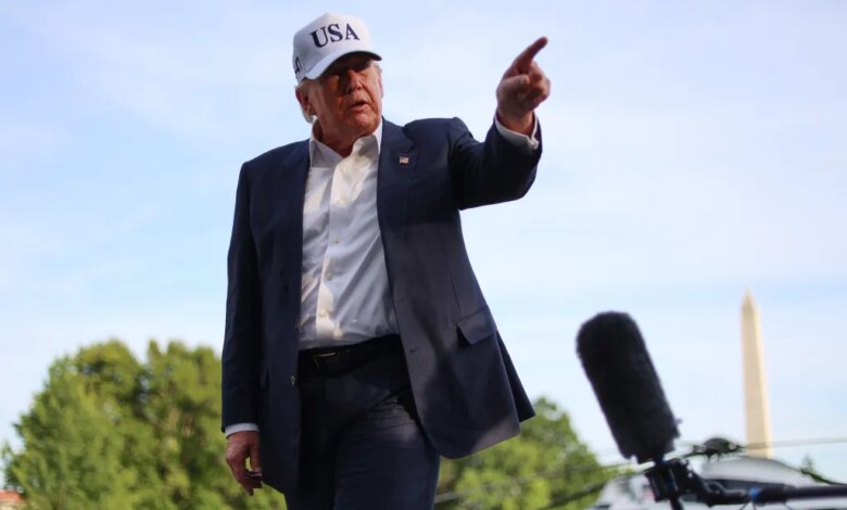 Donald Trump speaks to reporters outside the White House, gesturing with his right hand.