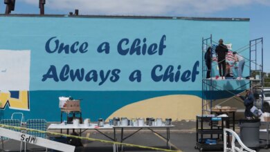 Students from Massapequa High School paint a mural that reads, "Once a Chief, Always a Chief."