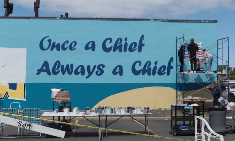 Students from Massapequa High School paint a mural that reads, "Once a Chief, Always a Chief."