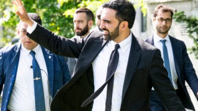 New York City Mayor Zohran Mamdani waves as he arrives for a press conference on housing in Queens.