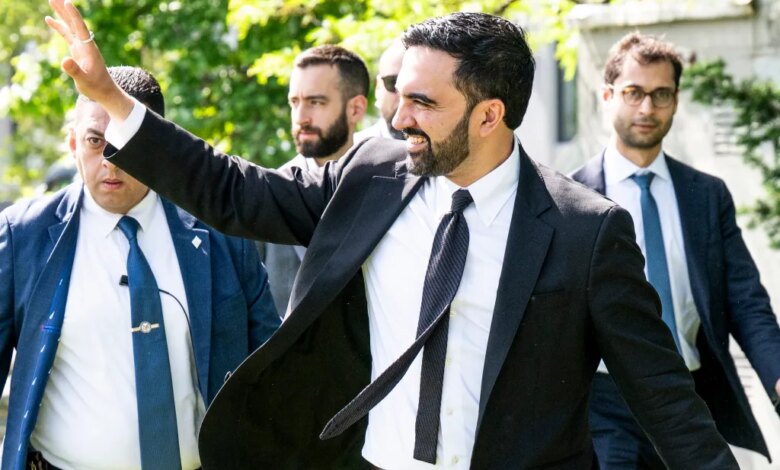 New York City Mayor Zohran Mamdani waves as he arrives for a press conference on housing in Queens.