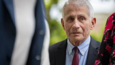 Dr. Anthony Fauci in a suit and tie looks to his right at the 33rd Annual White House Correspondents' Garden Brunch.