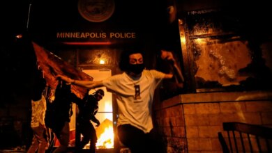 Protesters in Minneapolis setting fire to the entrance of a police station.