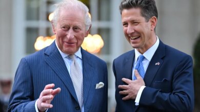 King Charles III and Sir Christian Turner laughing at a garden party.