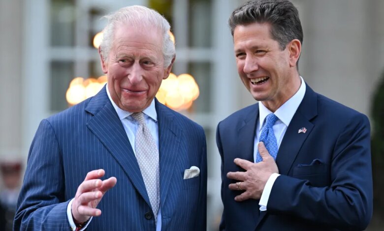 King Charles III and Sir Christian Turner laughing at a garden party.