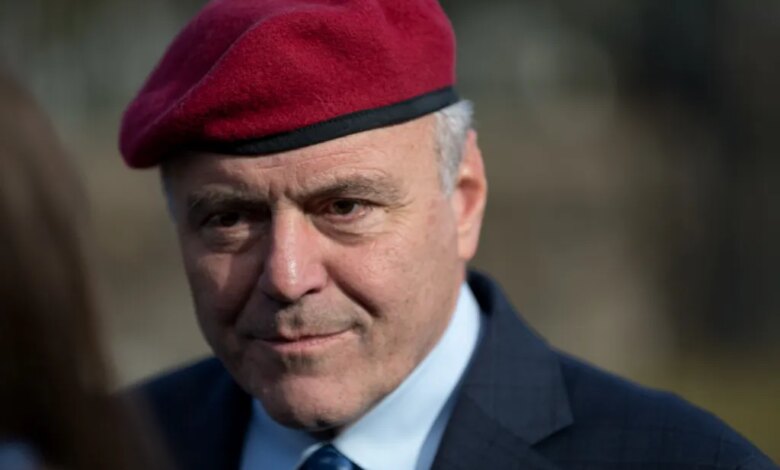 Close-up of Curtis Sliwa wearing a red beret, blue shirt, and blue tie.