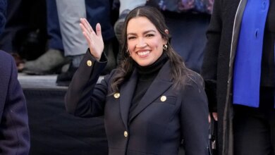 Rep. Alexandria Ocasio-Cortez waving to crowd at City Hall in New York City