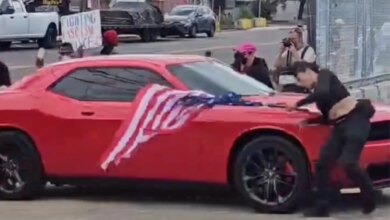 Anti-ICE protester hit by car while waving upside-down US flag outside Delaney Hall