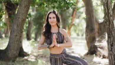 Ashley Phillips in a yoga tree pose outdoors.
