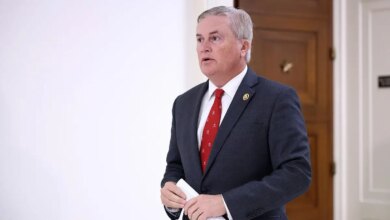 Rep. James Comer walking in a hallway before a closed-door interview