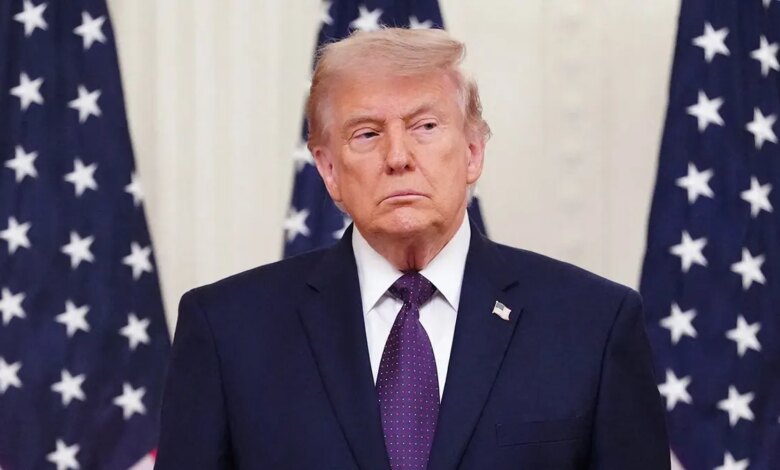 President Donald Trump in front of American flags
