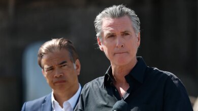 California Governor Gavin Newsom and Attorney General Rob Bonta standing at a news conference outdoors