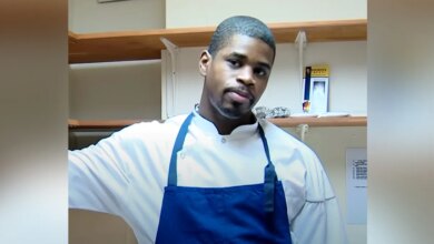 Tafari Campbell wearing white shirt and blue apron