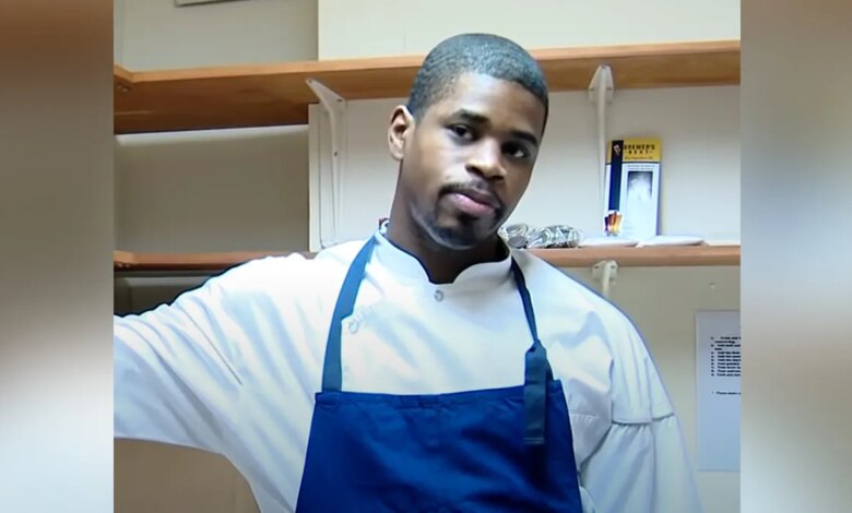 Tafari Campbell wearing white shirt and blue apron