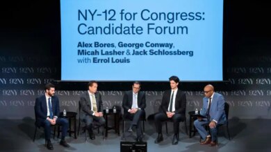 Five men sitting on stage during the "NY-12 for Congress: Candidate Forum."