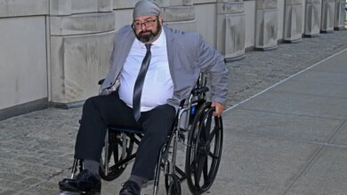 John Merrone in a wheelchair outside Brooklyn Federal Court.