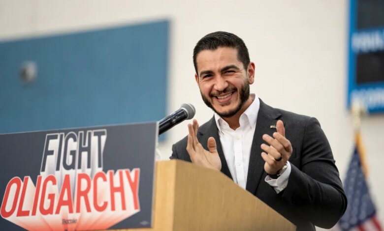Abdul El-Sayed speaking from a podium with a "FIGHT OLIGARCHY" sign.
