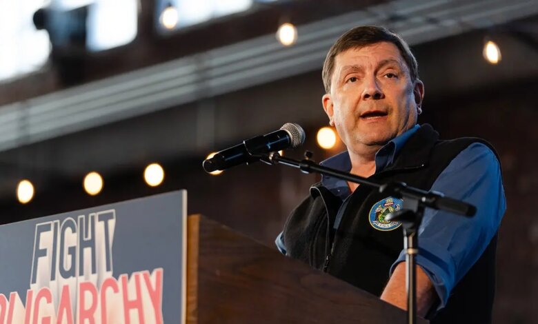 Troy Jackson speaking at a microphone during a political campaign event in Portland, Maine.