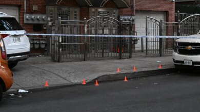 Crime scene tape and orange cones mark a residential area on Grand Avenue in the Bronx where a man was fatally shot.