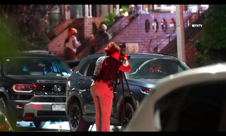 A NYPD Crime Scene Unit member photographs the scene of a shooting in Brooklyn, NY.