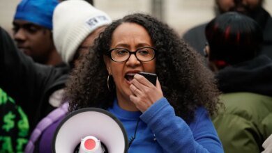 Chair and Executive Director of the NYC Commission on Racial Equity Linda Tigani speaks into a microphone during a rally in New York City.